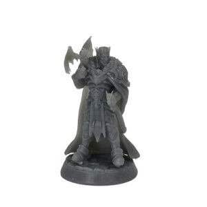 An unpainted grey resin miniature of a fantasy king standing against a white background. The figure is clad in heavy, ornate armor and a crown, wearing a long flowing cape, with a small winged dragon perched on his right forearm. He is mounted on a textured cobblestone base.