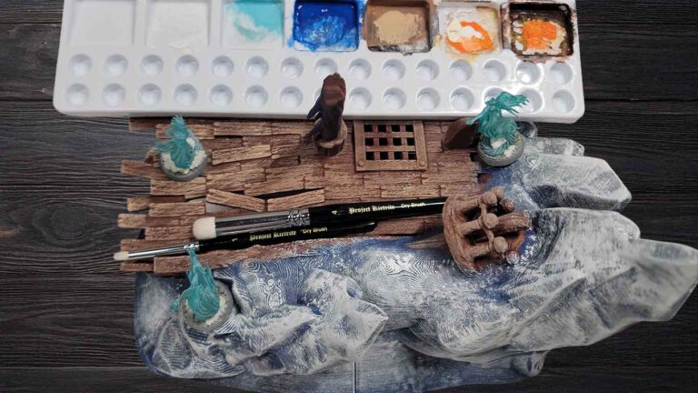 some terrain and miniatures showcasing dry brushing technique