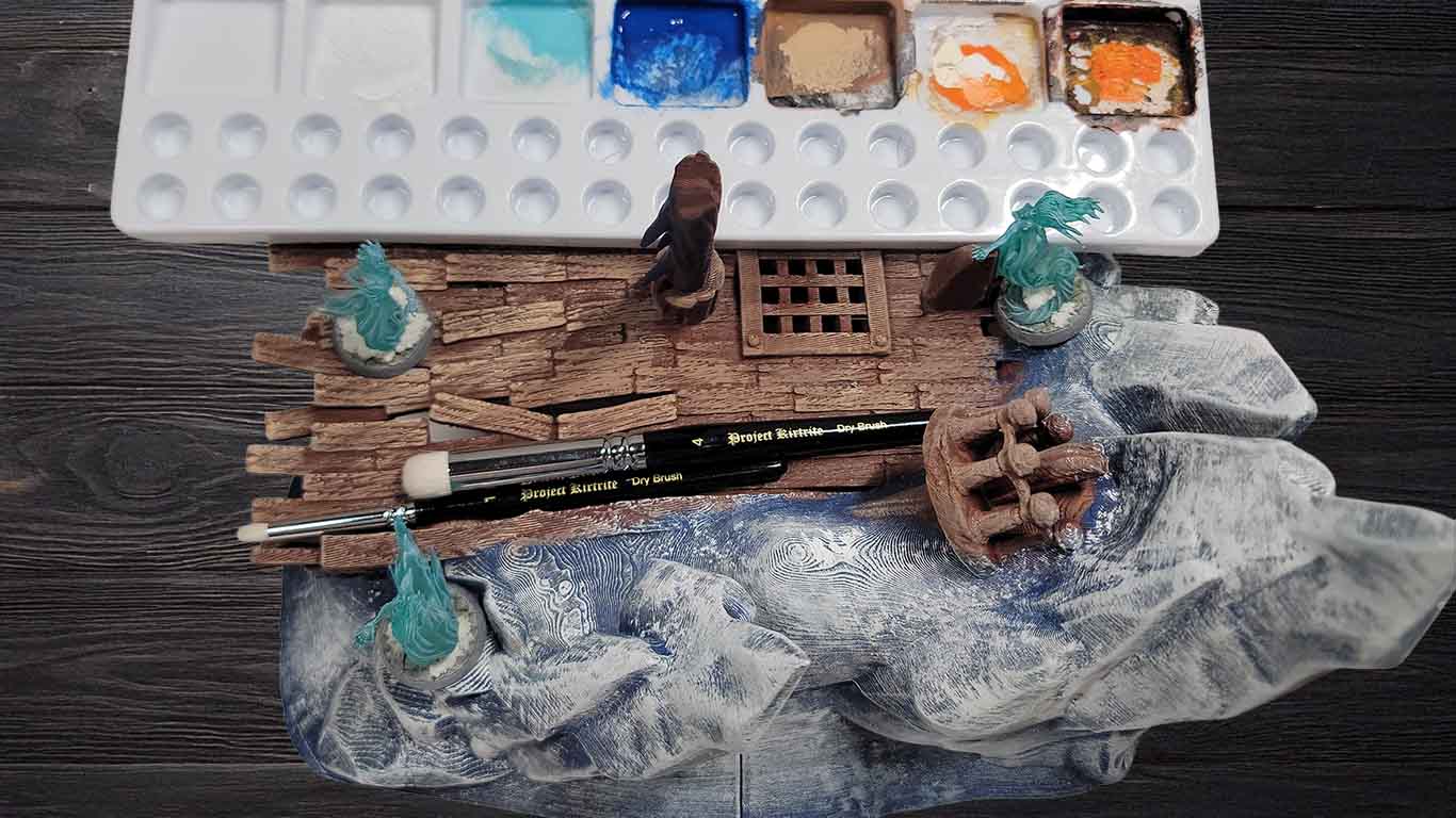 some terrain and miniatures showcasing dry brushing technique